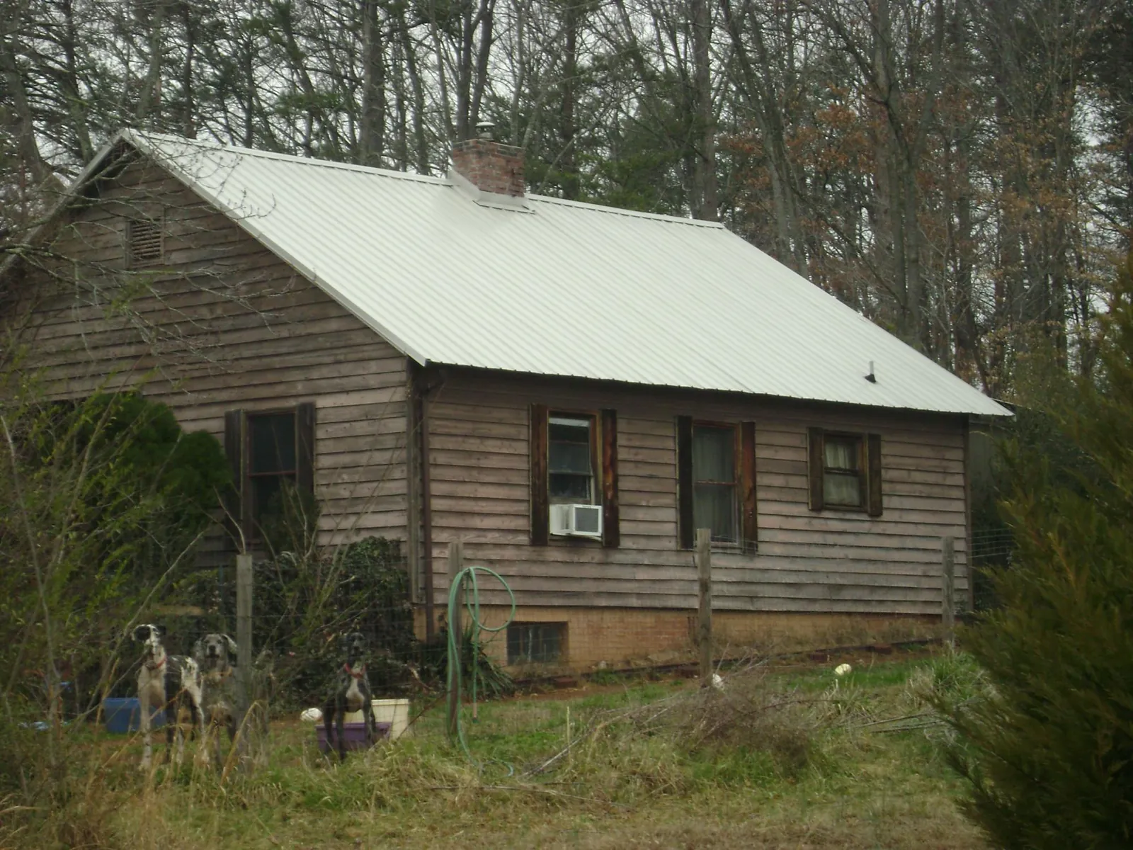 White metal roof on an old wood sided farmhouse, from a Metal Roof Installation job in Sharps